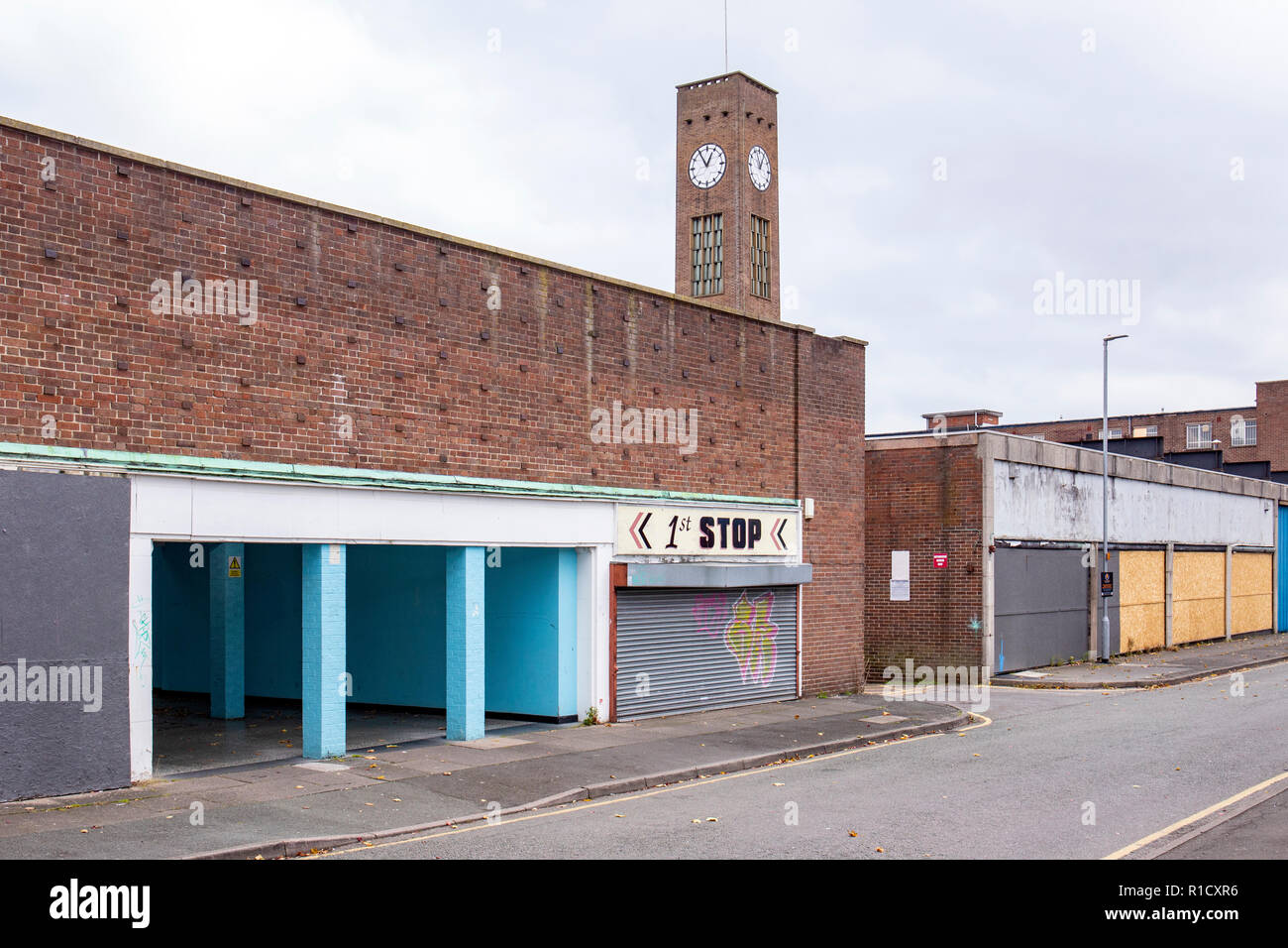 Underpass with closed down shops and clock tower in Crewe Cheshire UK