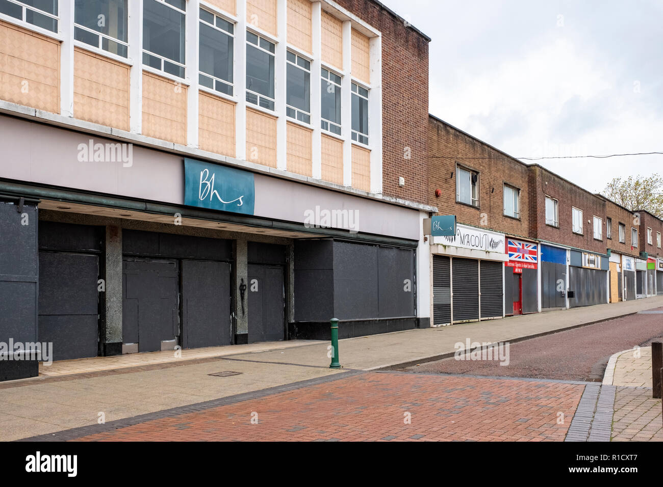 Whole street with shops closed down and boarded up in Crewe Cheshire UK Stock Photo