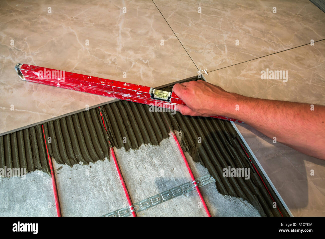 Ceramic Tiles And Tools For Tiler Worker Hand Installing Floor