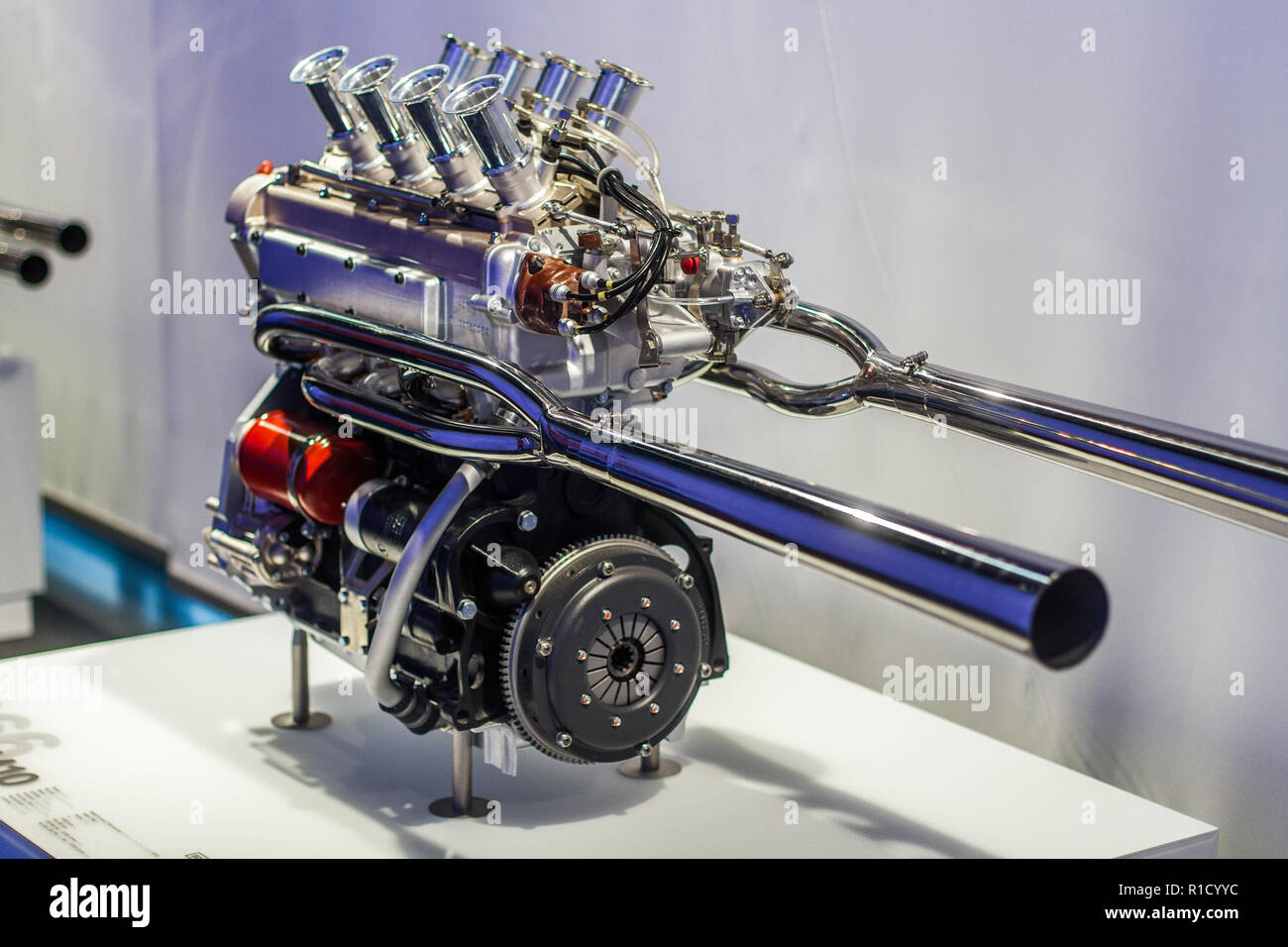 Inline four sport engine with polished exhaust and throttles Stock Photo