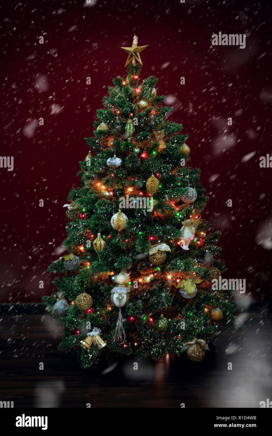 view of nice decorated christmas tree on deep red back Stock Photo