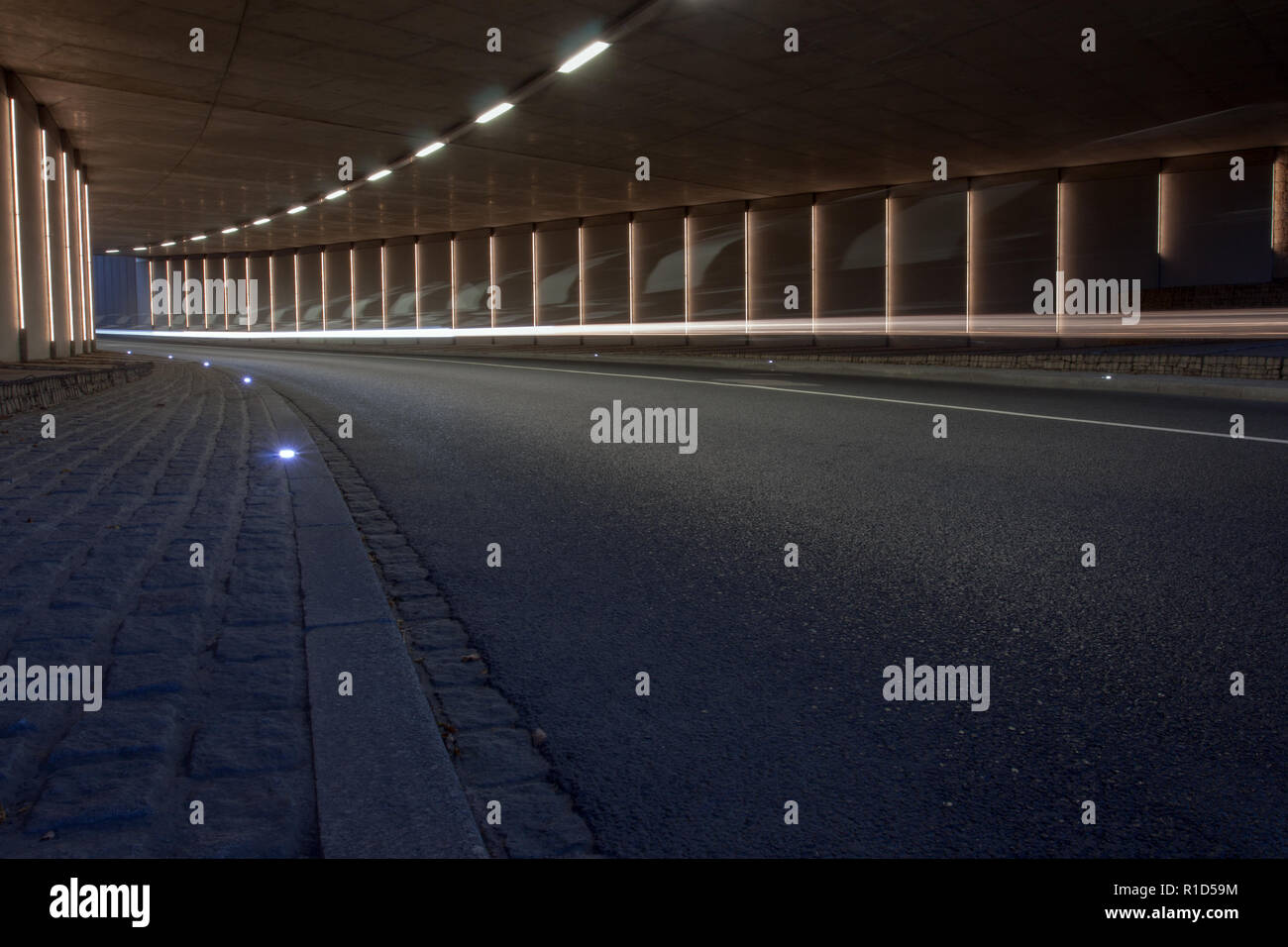Illuminated curved road tunnel with motion blur Stock Photo Alamy