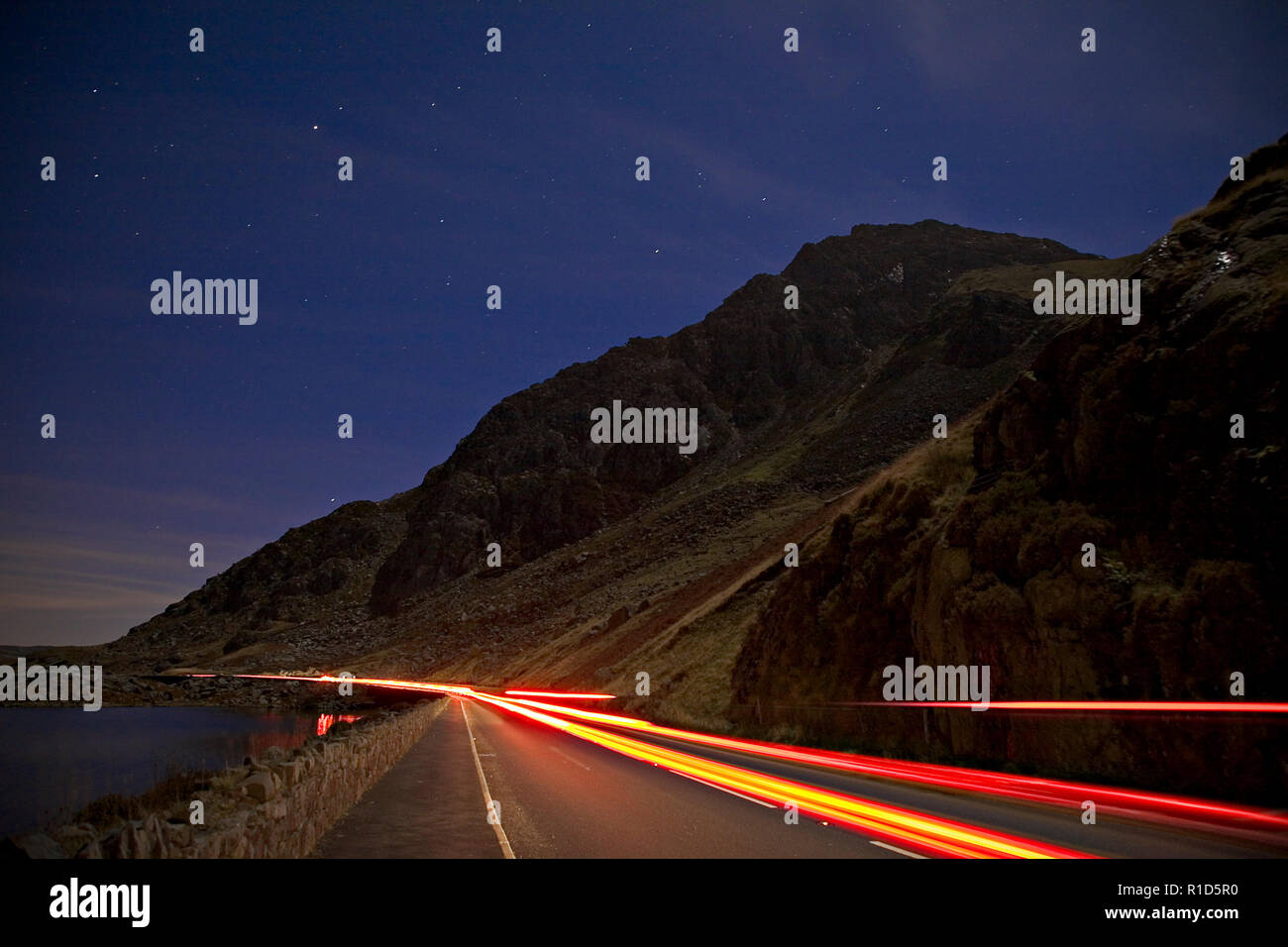 Tryfan mountain at night with traffic trails, Snowdonia, North Wales Stock Photo
