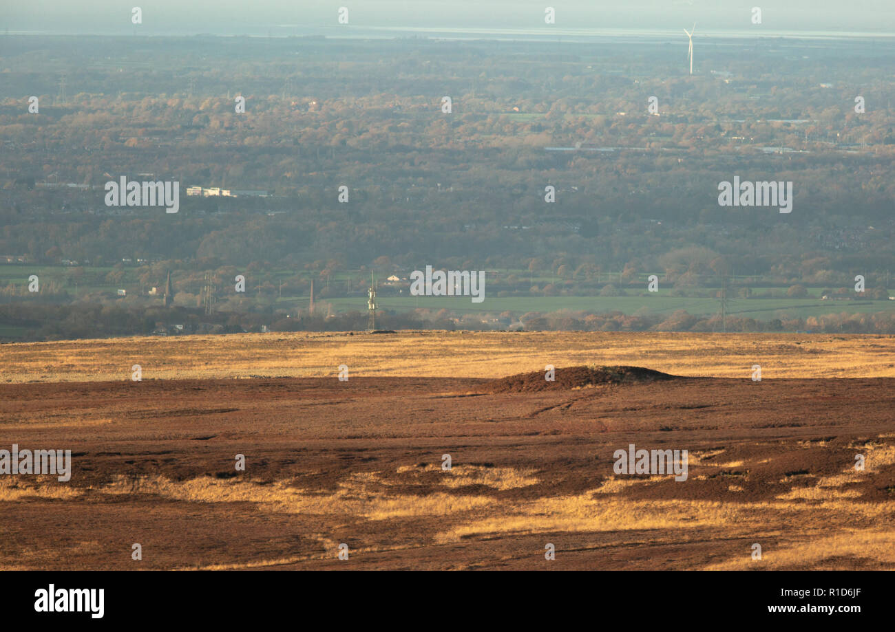 Neolithic tumulus knowna s the the Round Loaf on the West Pennine Moors with a distant landscape  featuring the Ribble Estuary in the background. Stock Photo