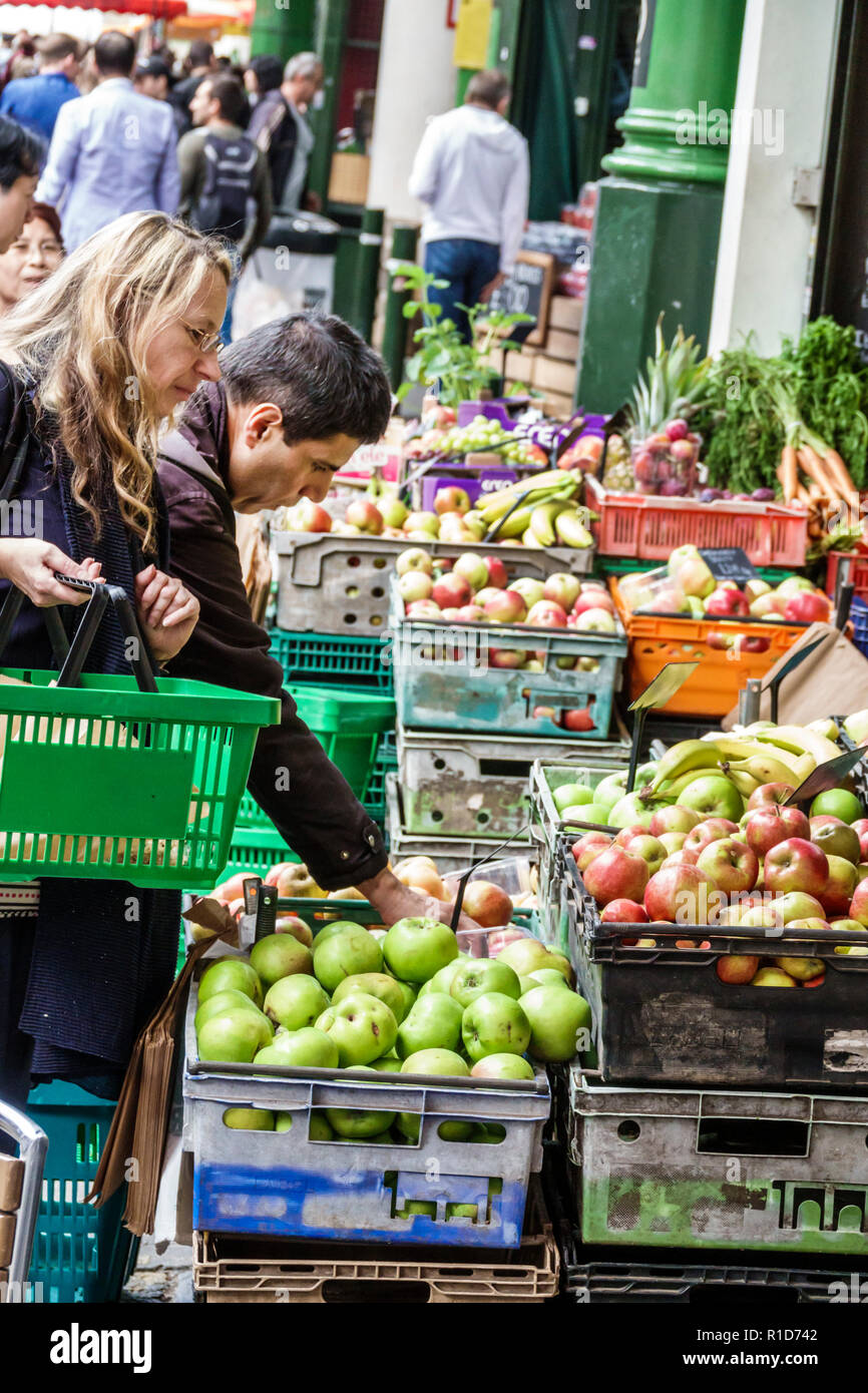 London England,UK,South Bank Southwark,Borough Market,vendors stalls,produce,fruits vegetables,apple crates,woman female women,man men male,shopping s Stock Photo