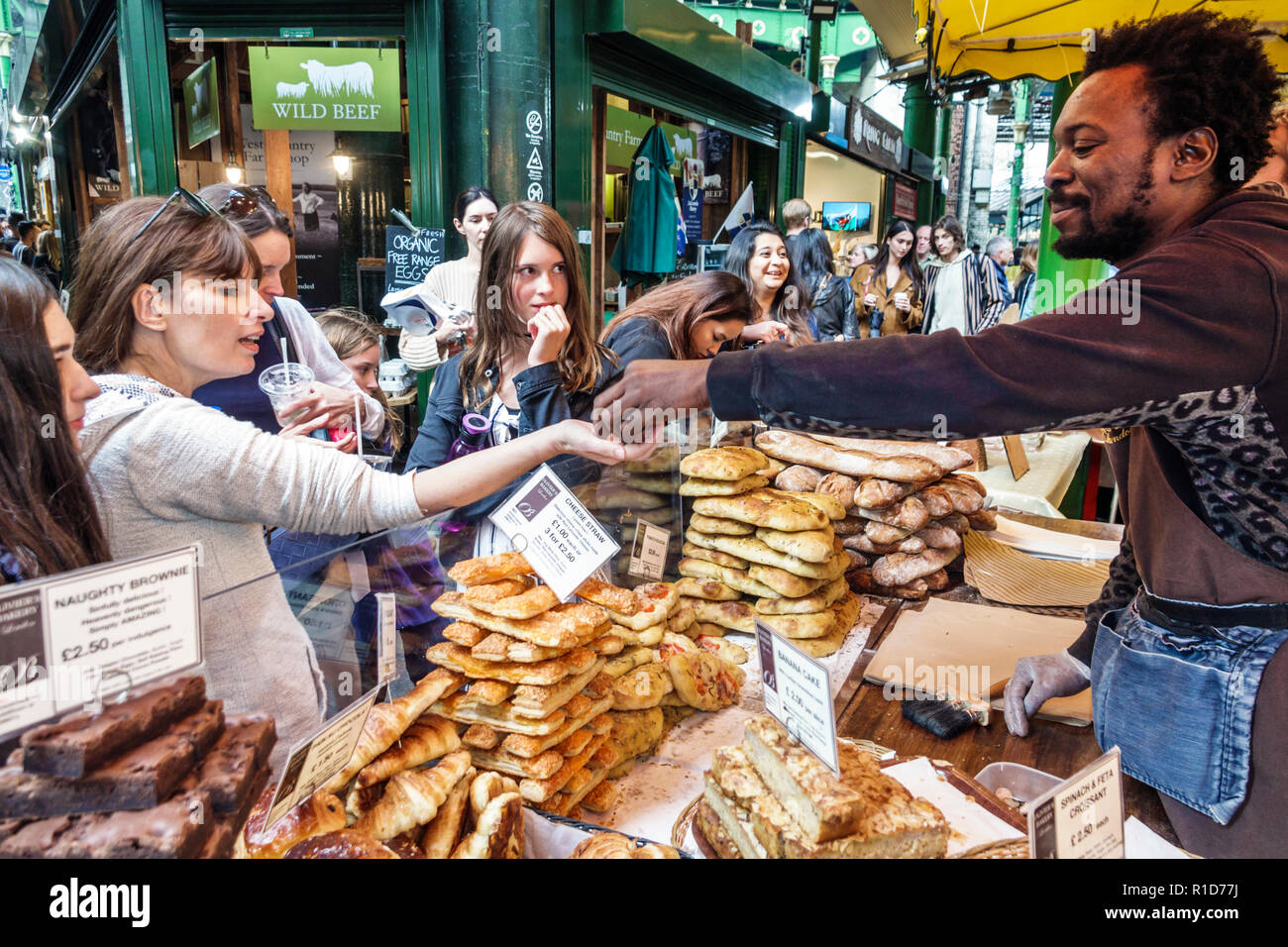 London England,UK,South Bank Southwark,Borough Market,vendors stalls,Olivier's bakery,pastries,brownies,Black man men male,woman female women,buying,s Stock Photo