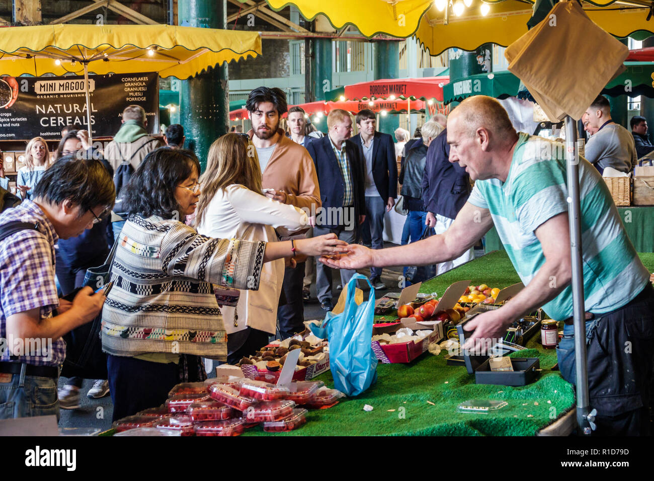 London England,UK,South Bank Southwark,Borough Market,vendors stalls,produce,fruits vegetables,Asian woman female women,man men male,shopping shopper Stock Photo