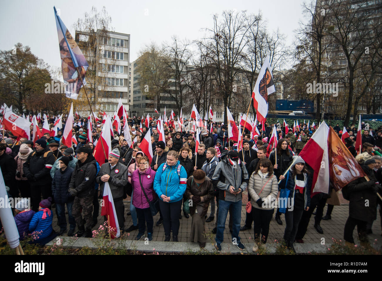 Members of the National Radical Camp (ONR) and the conservative right wing associations are seen holding flags while praying next to the Polish Parliament before the official march. Days before the Independence Day, the mayor of warsaw, Hanna Gronkiewicza banned the Independence Day march organized by the extreme right wing associations while on the same day, the Polish government announced a state march that would depart from the same place as they banned the Independence Day march. On November 09th The Polish government and the organizers of the march of nationalists agreed to hold a joint m Stock Photo