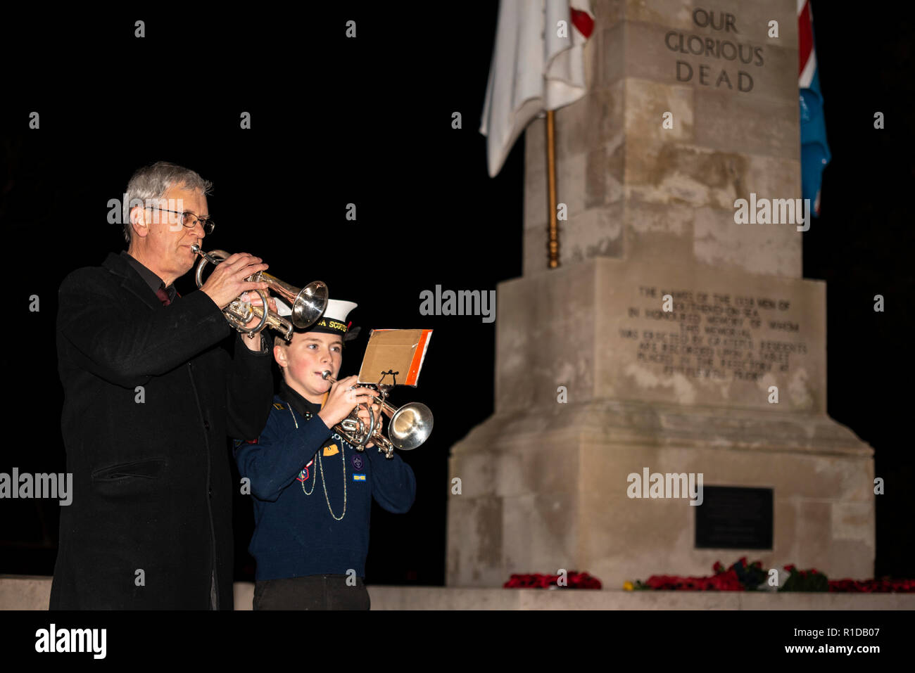 Southend Cenotaph, Clifftown Parade, Southend on Sea, Essex, UK. Buglers performed The Last Post at 18:55 before the lighting of a 'Beacon of Light' at 19:00, an act echoed around the country to symbolise an end to the darkness of war and a return to the light of peace. Buglers were Will Rodgers, 13, of Southend Brass Band and David Hurrell. Armistice Day. Remembrance Sunday. Centenary of the end of World War One, the Great War, the First World War Stock Photo