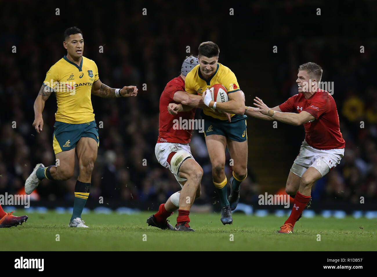 Cardiff, UK. 10th Nov 2018. Jack Maddocks of Australia © is stopped by  Jonathan Davies and Gareth Anscombe of Wales (r). Wales v Australia , Under  Armour series Autumn international rugby match