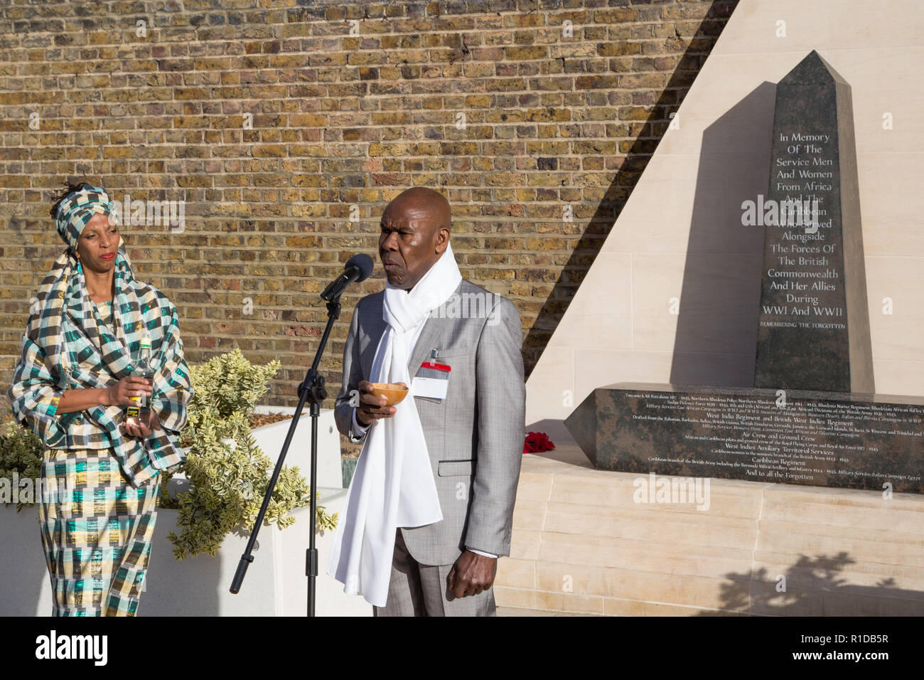 London UK 11th November 2018. Professor Gus Jhon performs a libation during Remembrance Armistice Day Parade at the African Caribbean War Memorial, Windrush Square, Brixton. Credit: Thabo Jaiyesimi/Alamy Live News Stock Photo