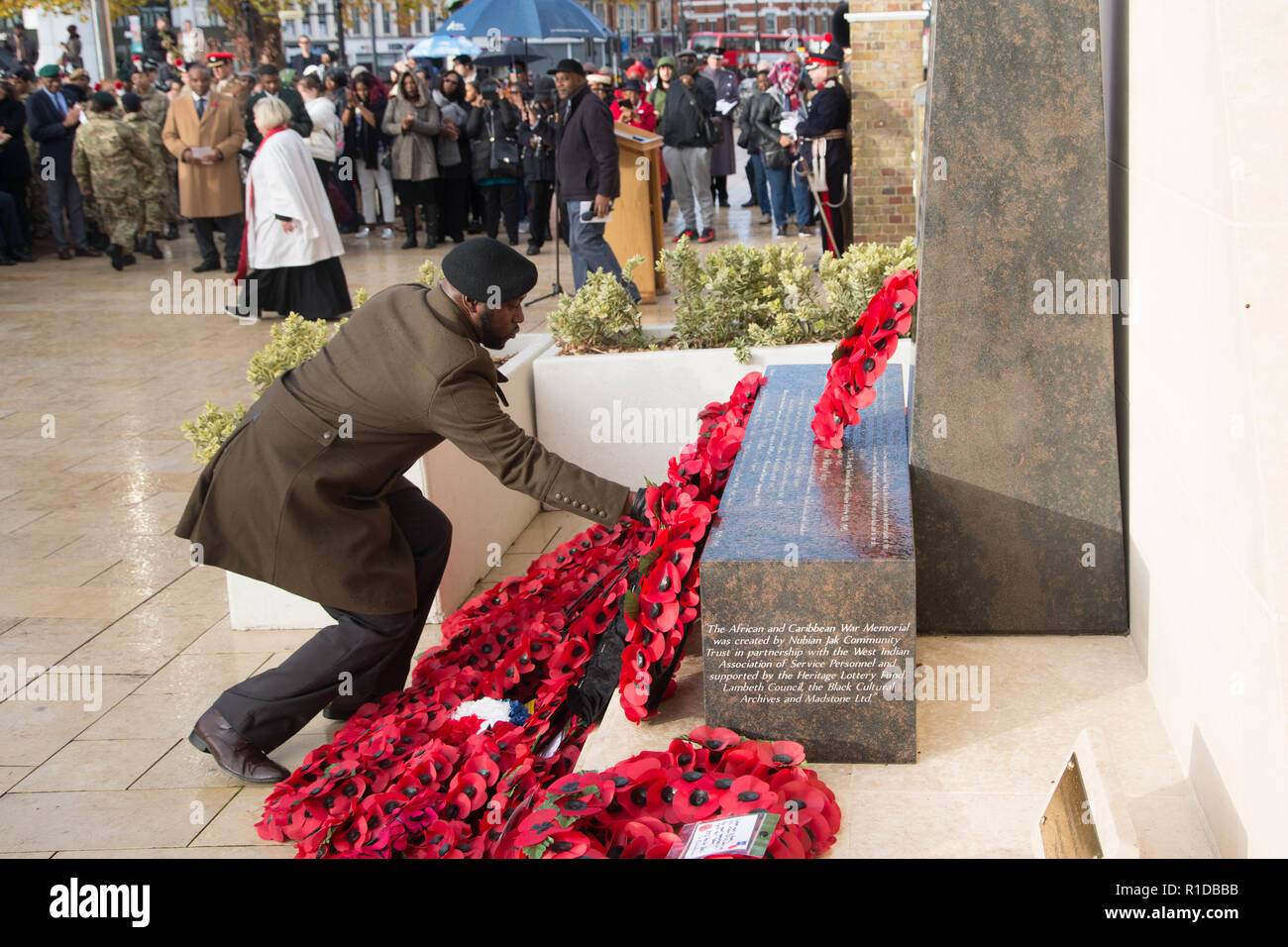 London UK 11th November 2018.  A man lays wreath at the Remembrance Armistice Day Parade at the African Caribbean War Memorial ,Windrush Square, Brixton. Credit: Thabo Jaiyesimi/Alamy Live News Stock Photo