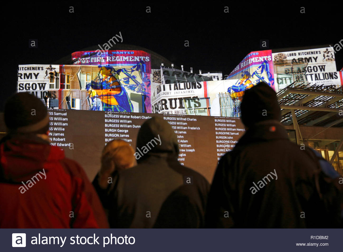 Edinburgh, United Kingdom. 11th November, 2018.  The Scottish Parliament building illuminated on Armistice day with images that tell the story of the world war 1 conflict alongside a Roll of Honour of those who died.   Credit: Craig Brown/Alamy Live News. Stock Photo