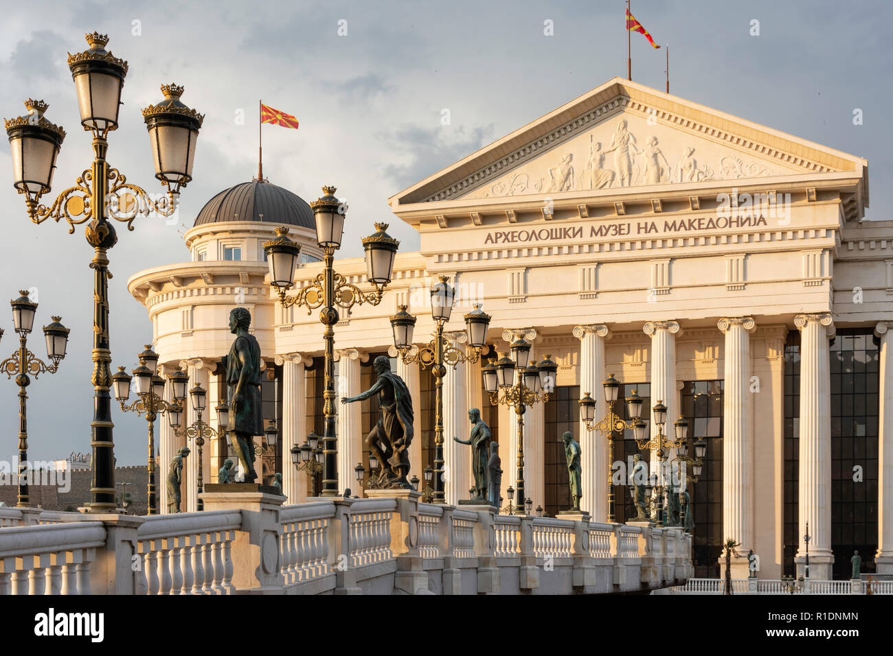 The Museum of Archaeology and Bridge of Civilization across River Vardar at sunset, Skopje, Skopje Region, Republic of North Macedonia Stock Photo