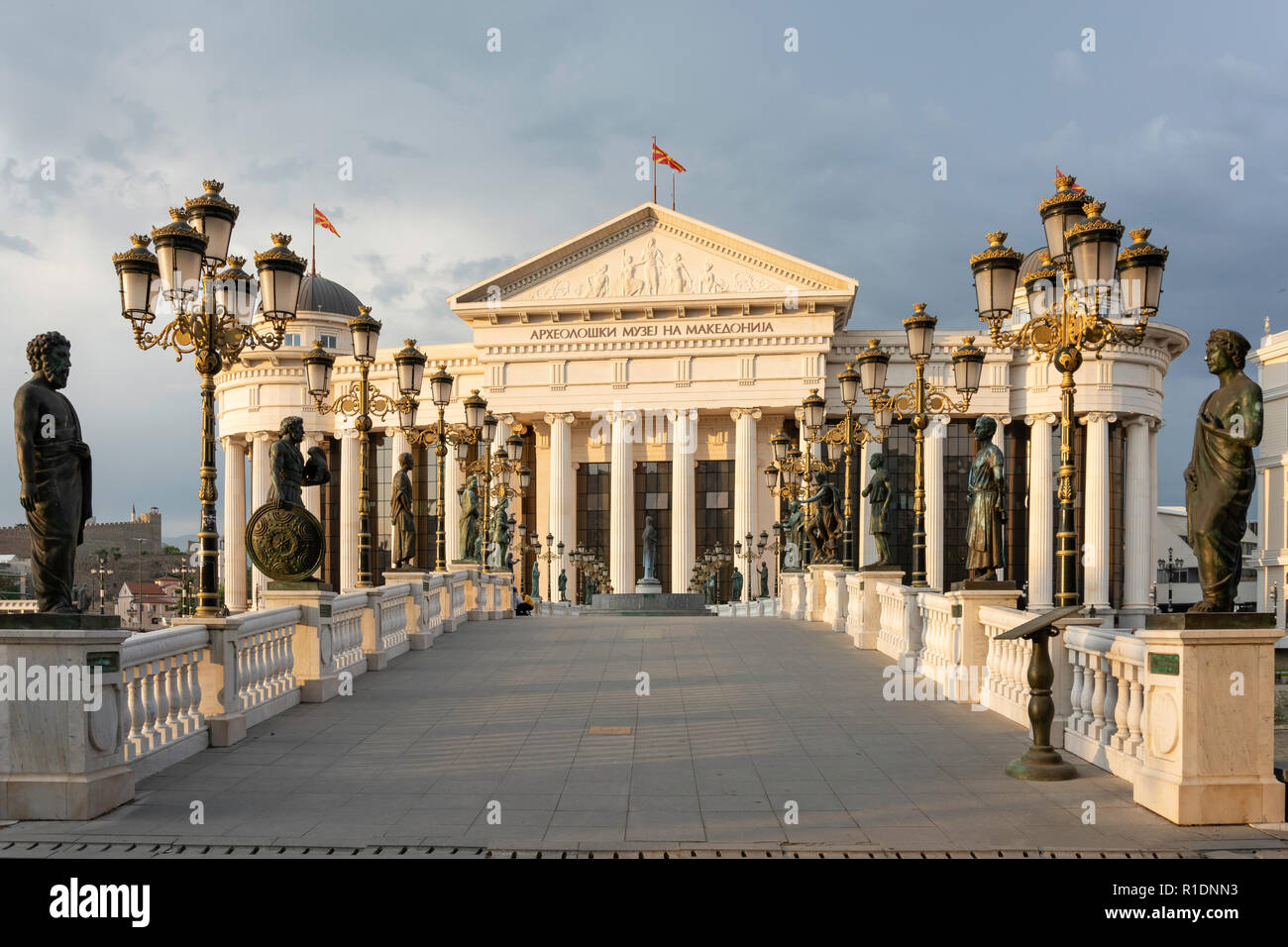 The Museum of Archaeology and Bridge of Civilization across River Vardar at sunset, Skopje, Skopje Region, Republic of North Macedonia Stock Photo