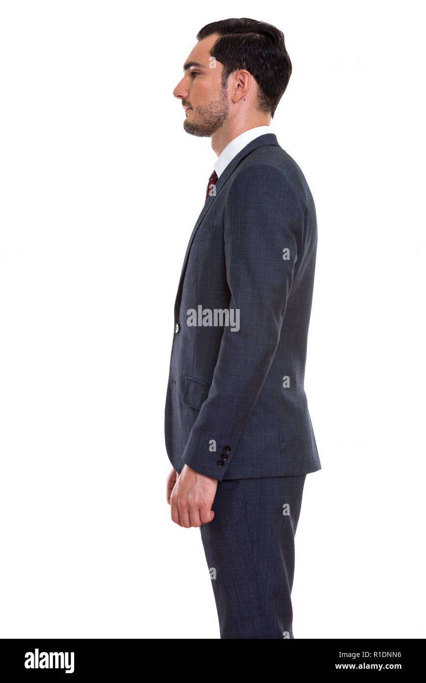 Profile view of young handsome businessman standing Stock Photo