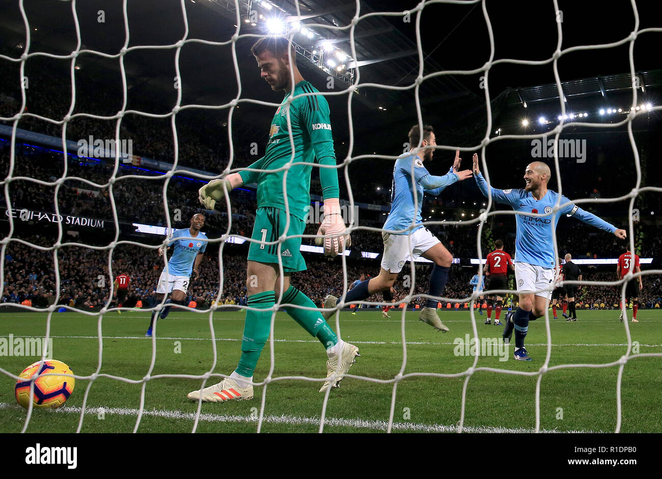 Manchester United goalkeeper David de Gea (left) appears dejected after Manchester City's Ilkay Gundogan (not in picture) scores his side's third goal of the game during the Premier League match at the Etihad Stadium, Manchester. Stock Photo