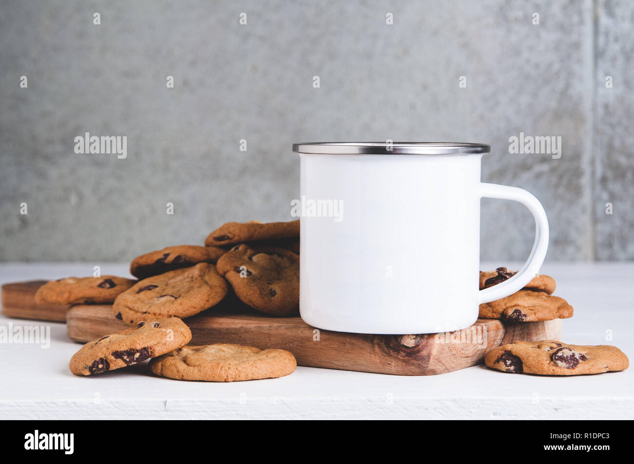 10oz white metal camp mug mock up with milk and cookies Stock Photo