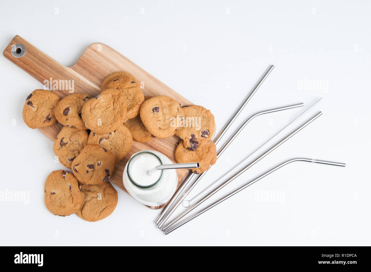 cookies and milk with reusable metal straws Stock Photo