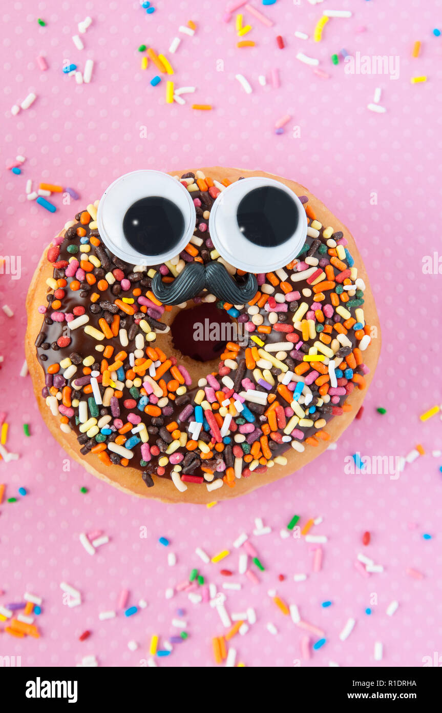 funny sprinkle donut with eyes and a mustache Stock Photo