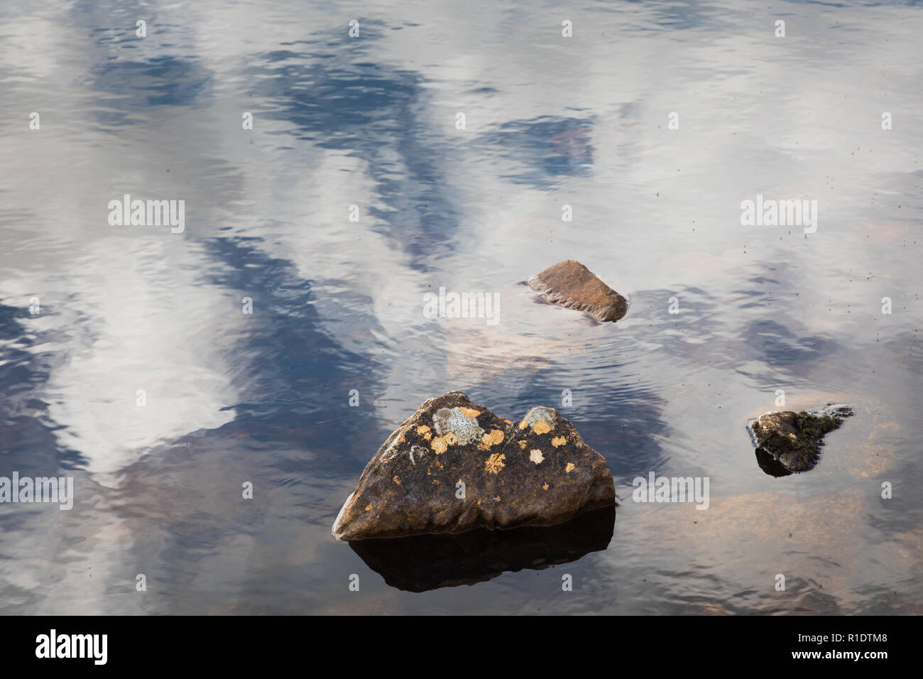 Clouds reflecting in water Stock Photo - Alamy