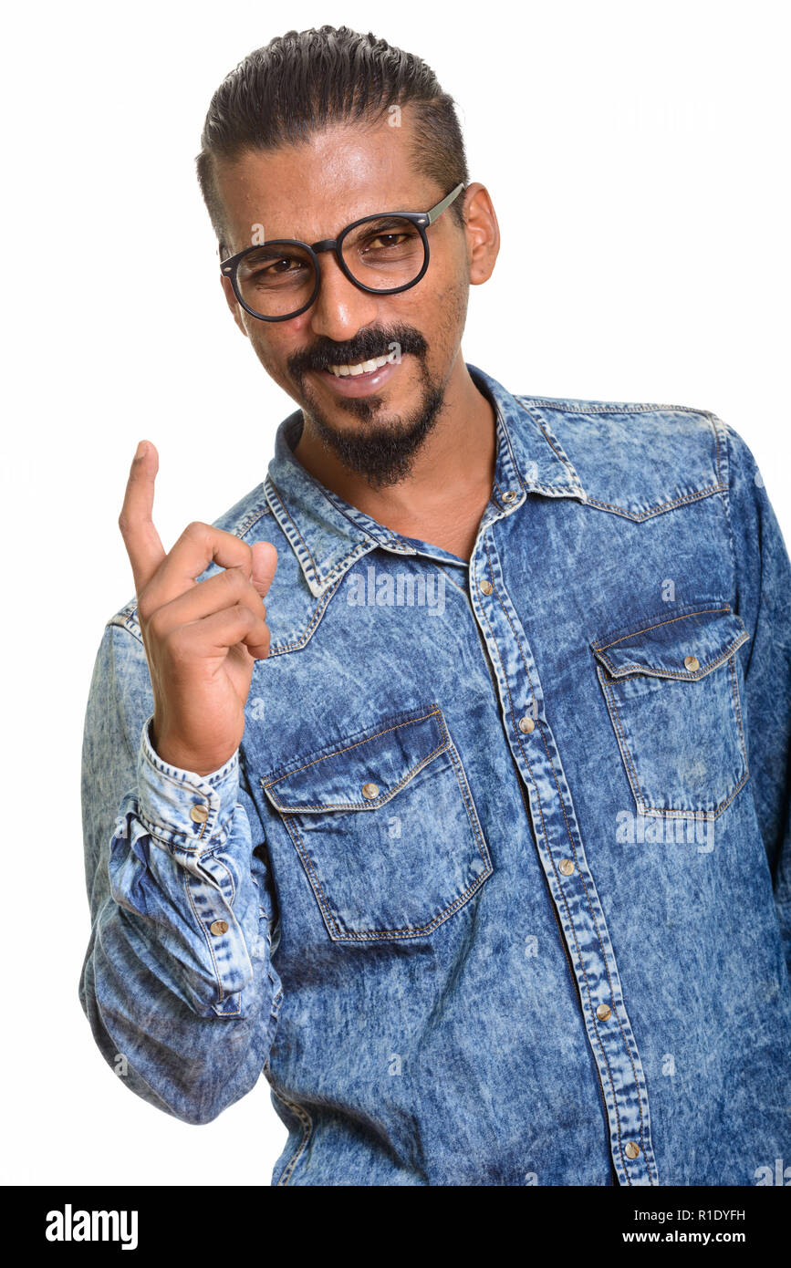 Young happy Indian man pointing finger up Stock Photo