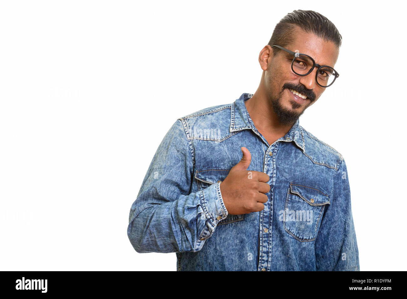 Young happy Indian man giving thumb up Stock Photo
