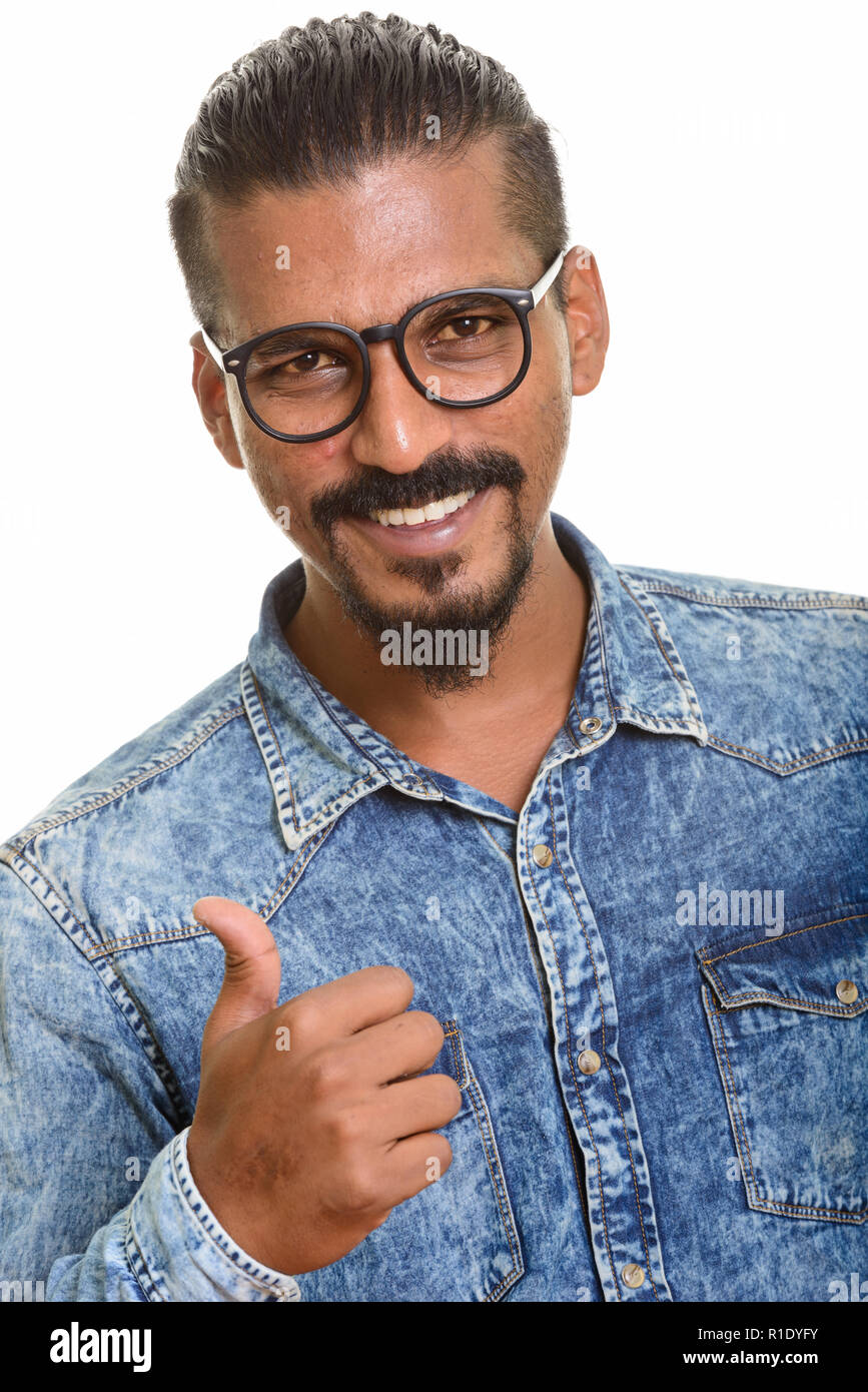 Young happy Indian man giving thumb up Stock Photo