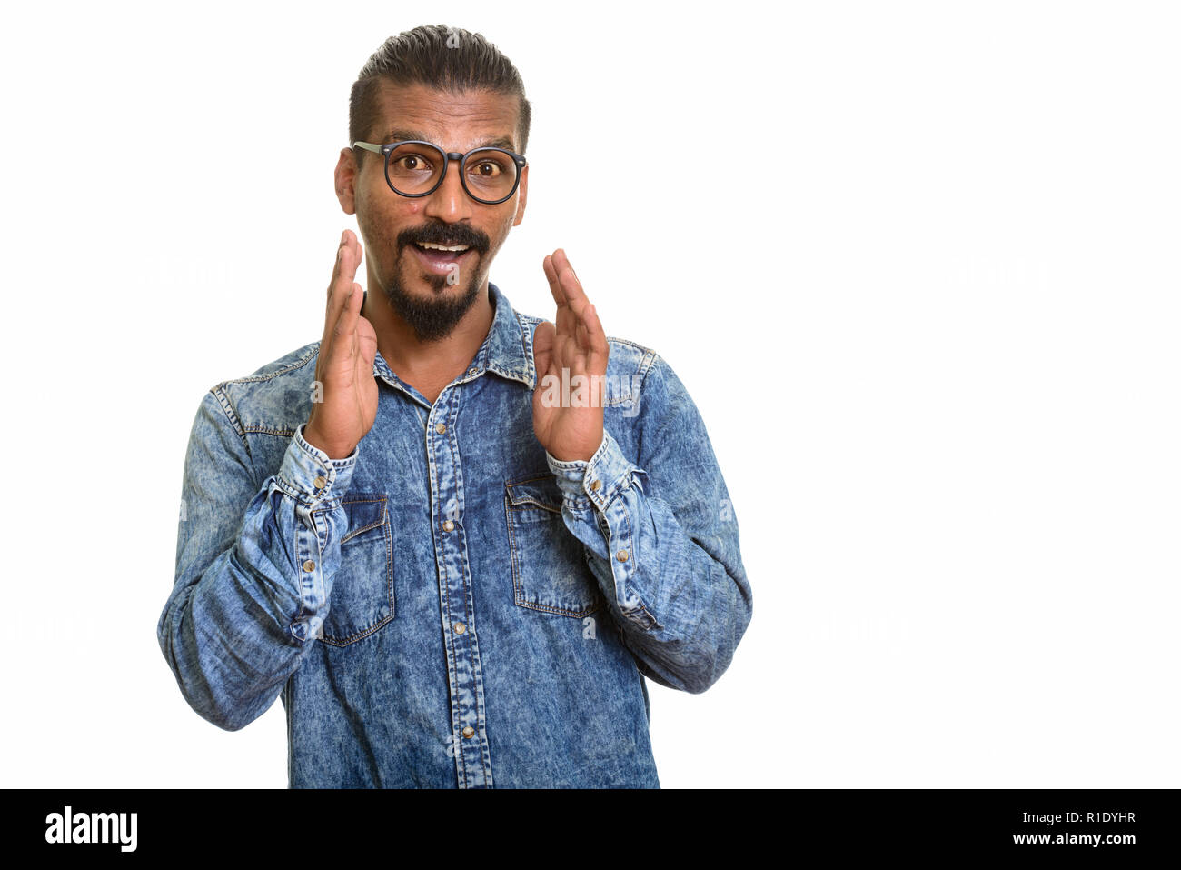 Young happy Indian man looking surprised studio portrait against white background Stock Photo