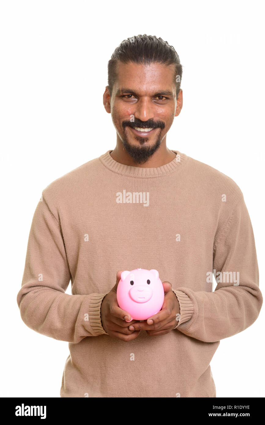 Young happy Indian man holding piggy bank Stock Photo - Alamy