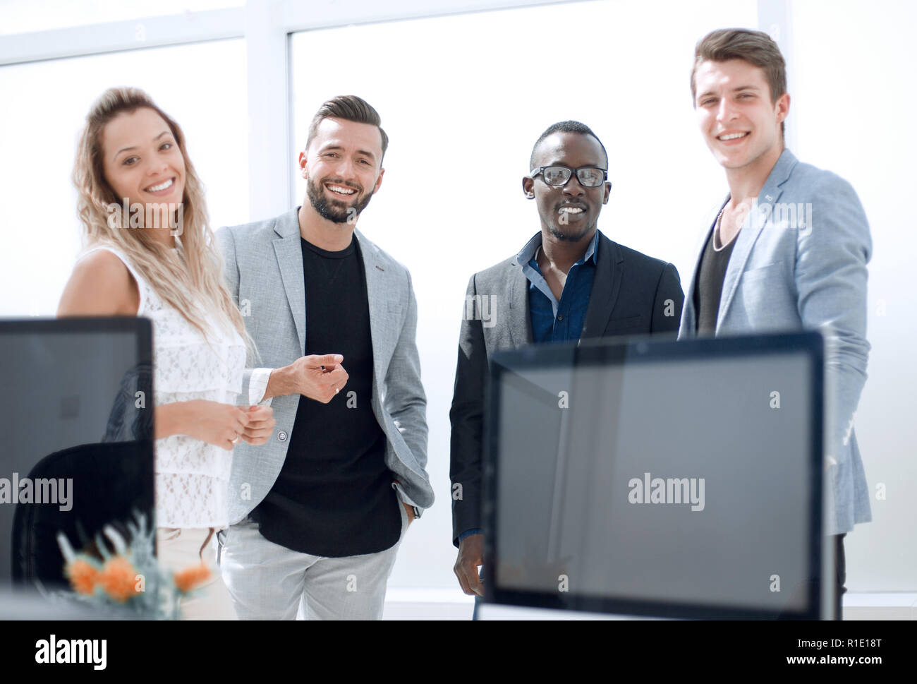 smiling business team standing in the office Stock Photo - Alamy