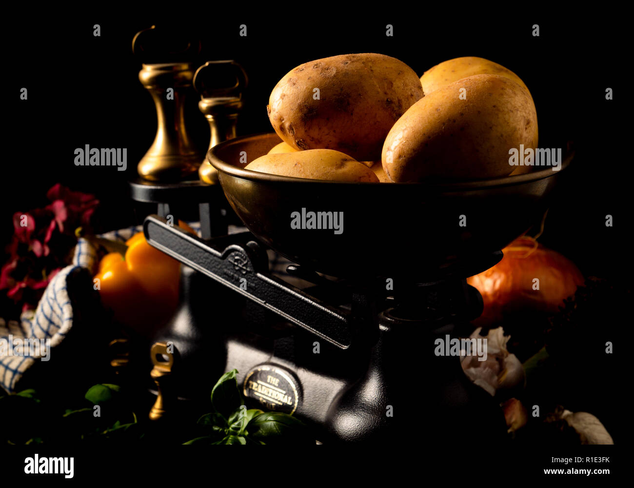 Old fashioned scales with potatoes Stock Photo