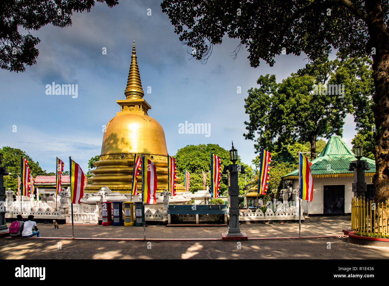 Dambulla Cave Temple, Sri Lanka. The typical Buddhism flags fly around the pagoda of the Golden Temple of Dambulla Stock Photo
