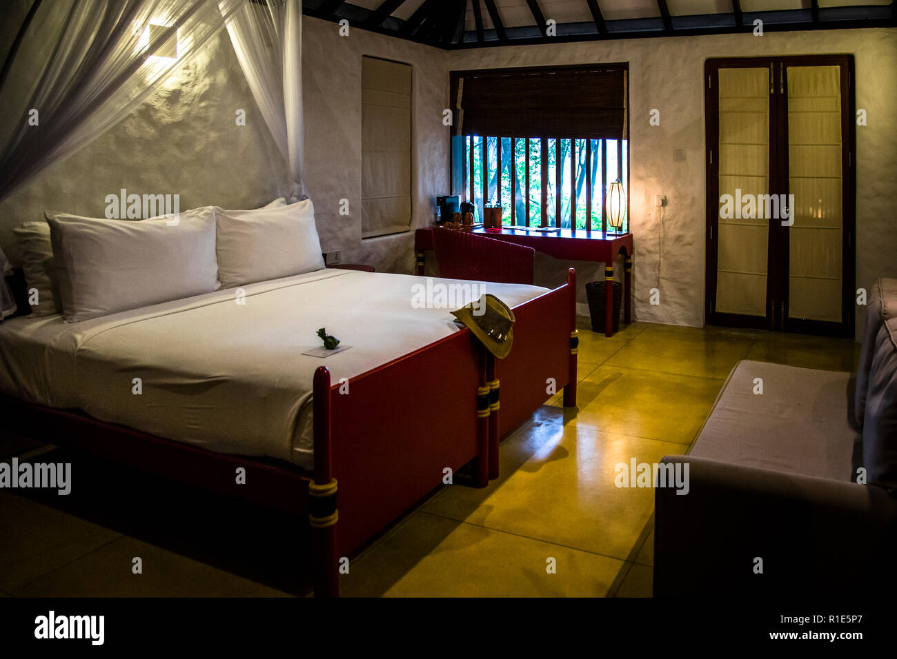 Hotel bedroom in Sri Lanka. Every bungalow is a perfect place to rest Stock Photo