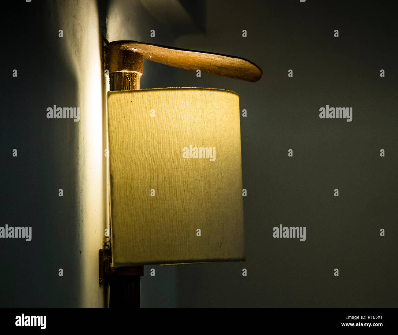 Wall lamp made of pick axe. The design of the rooms is modern and uses local materials. For example, lamps are made from the hoes typically used in rice cultivation Stock Photo