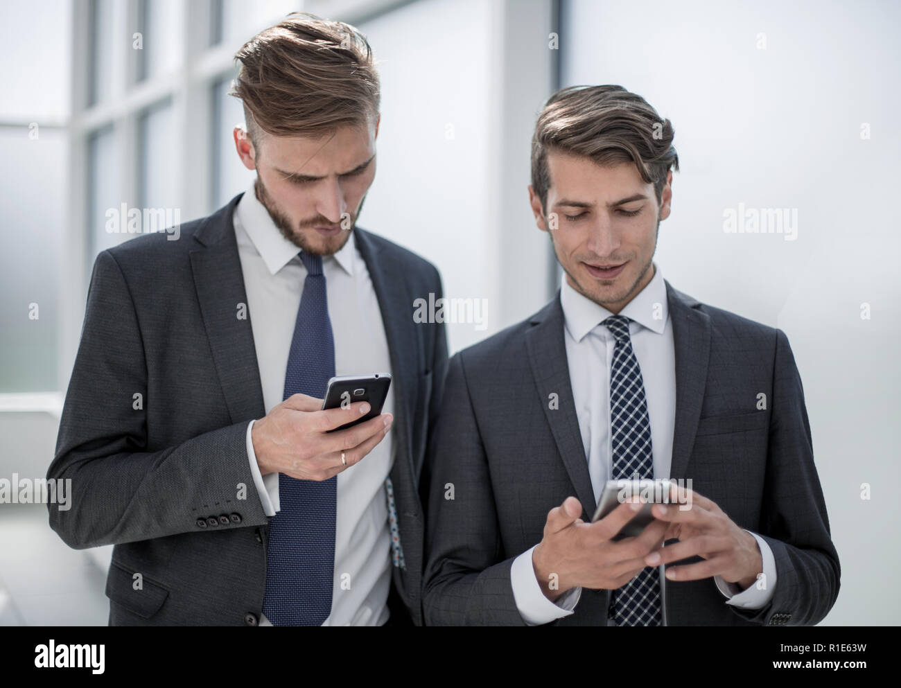 close up.young employees using their smartphones Stock Photo