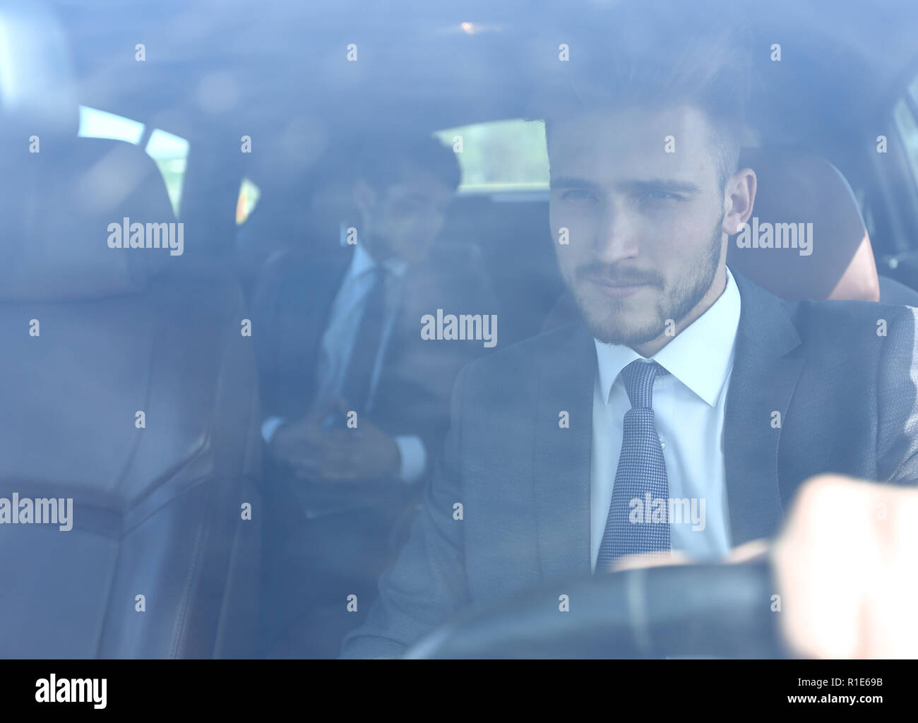 Businessman smiling behind car hi-res stock photography and images - Alamy
