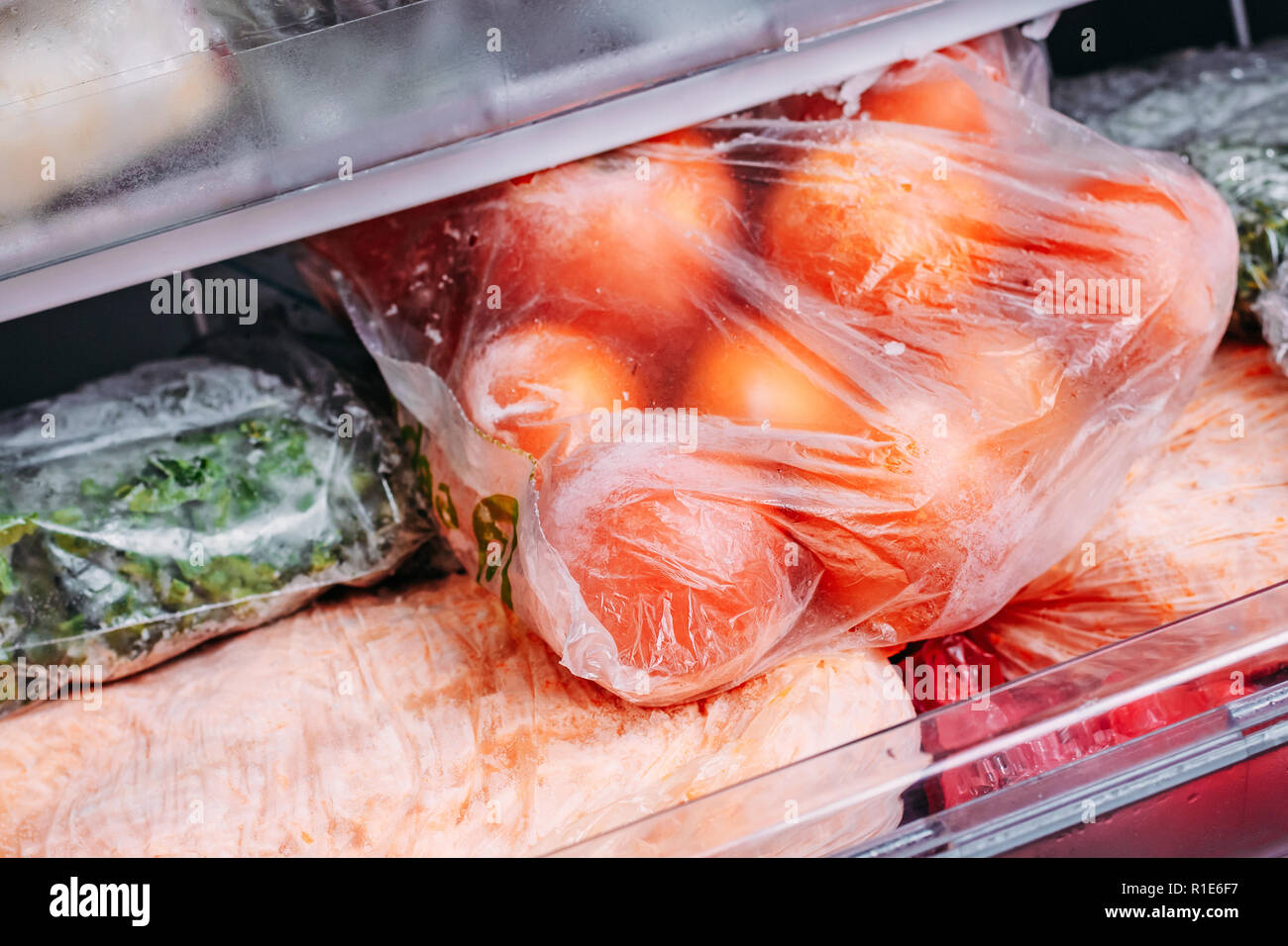 Different kind of deep frozen vegetables in plastic bags in
