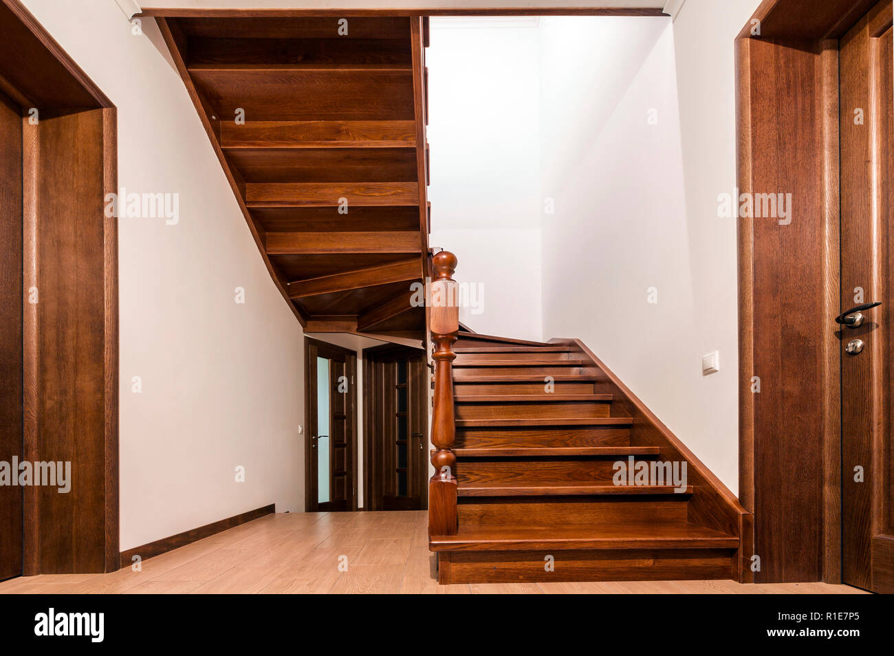 Modern brown oak wooden stairs and doors in new renovated house ...