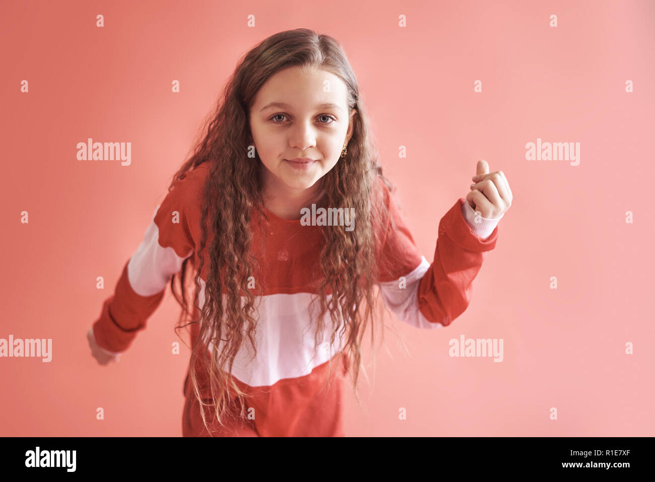 Young Beautiful Cute Girl Dancing On Red Background Modern