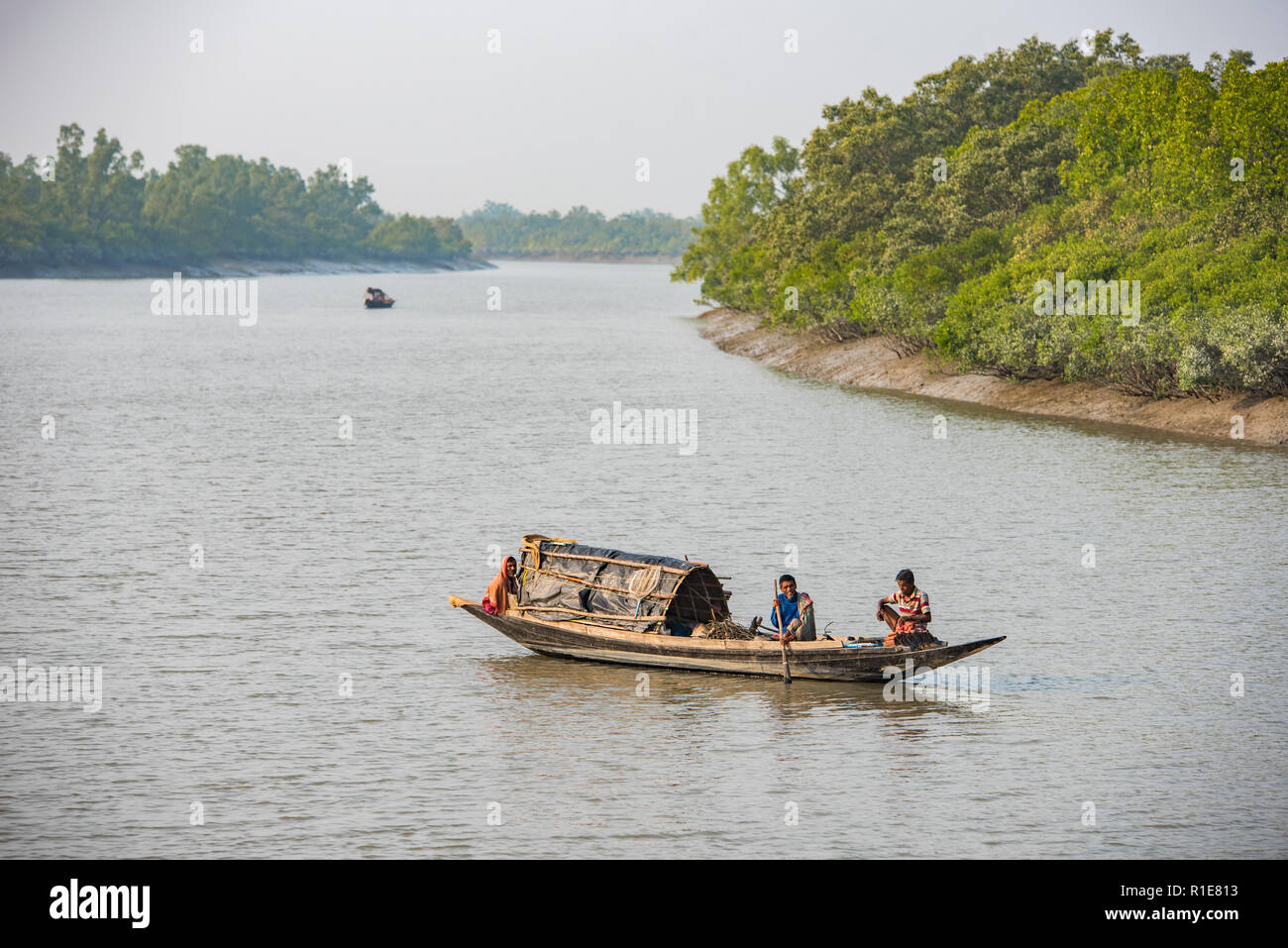 Fishermen on a bright sunny morning on their boat in the Subarbans, West Bengal, India Stock Photo