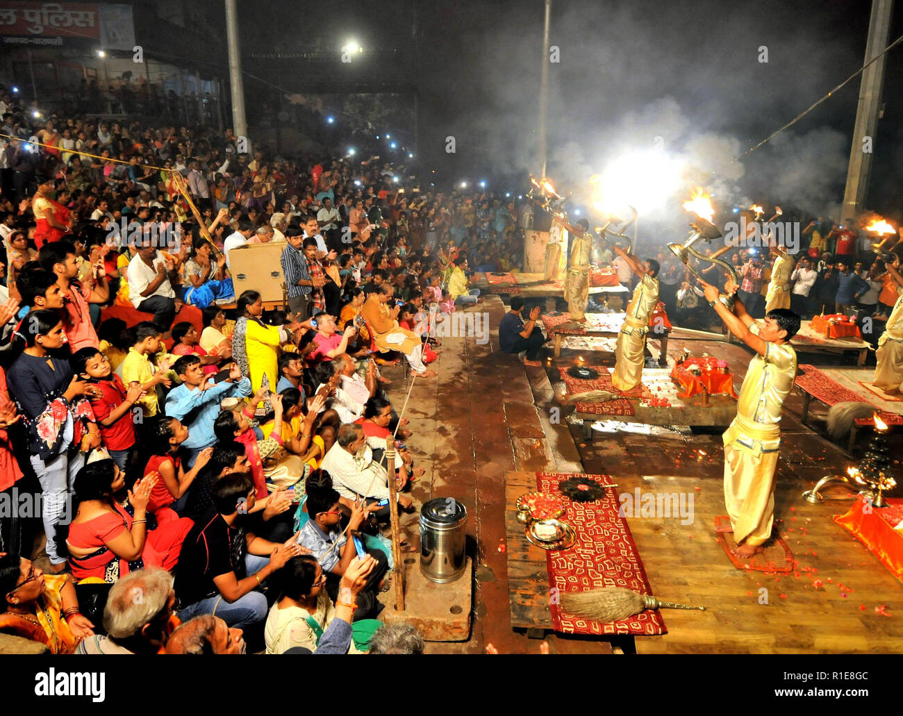 Varanasi, Hindus, Holy Ganges River. Brahmins or trainee priests reciting rituals at the nightly ceremony with flames in the form of candles. Stock Photo