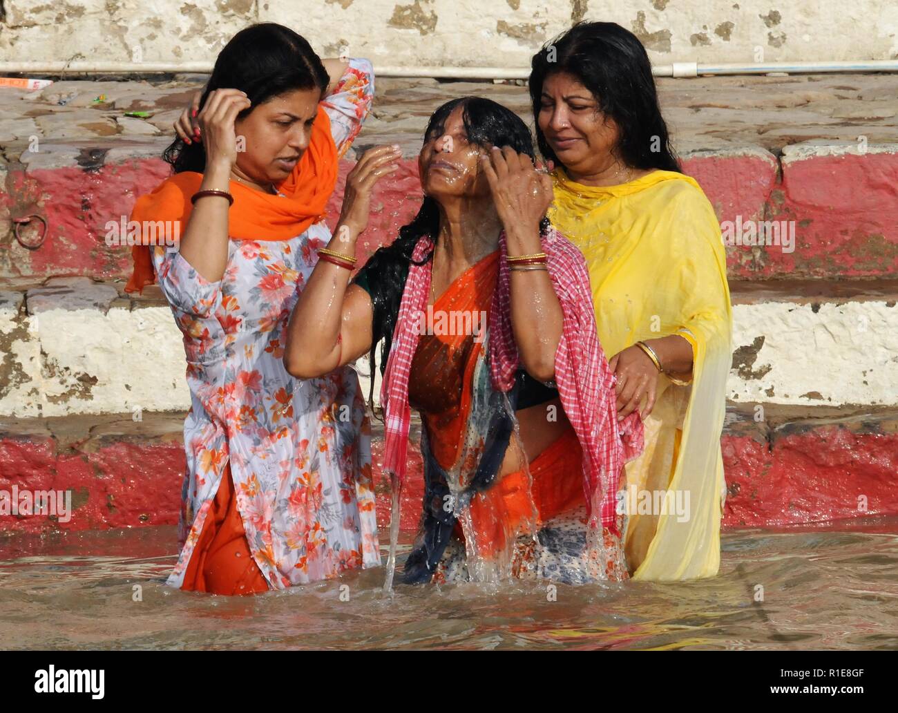 Varanasi, Hindus, Holy Ganges River. Hindus bathing in holy Ganges River and offering prayers. Stock Photo