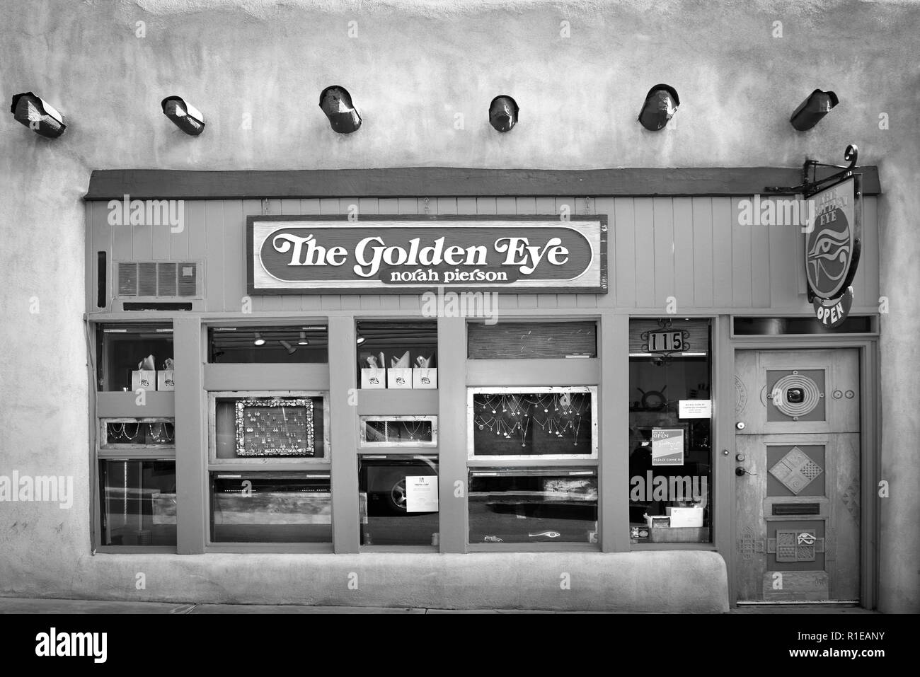 The charming old adobe building houses the Golden Eye jewelry store, specializing in handmade, high karat and gemstone jewelry in Santa Fe, NM, B & W Stock Photo