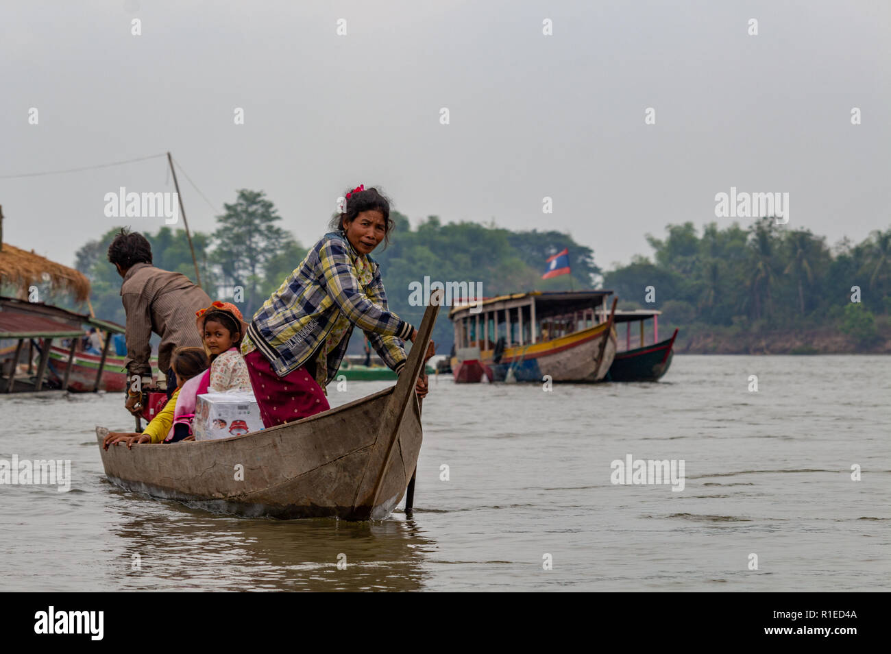 Nakasong, Laos - April 22, 2018: Family navigating through the Mekong river to Don Det island near the border with Cambodia Stock Photo