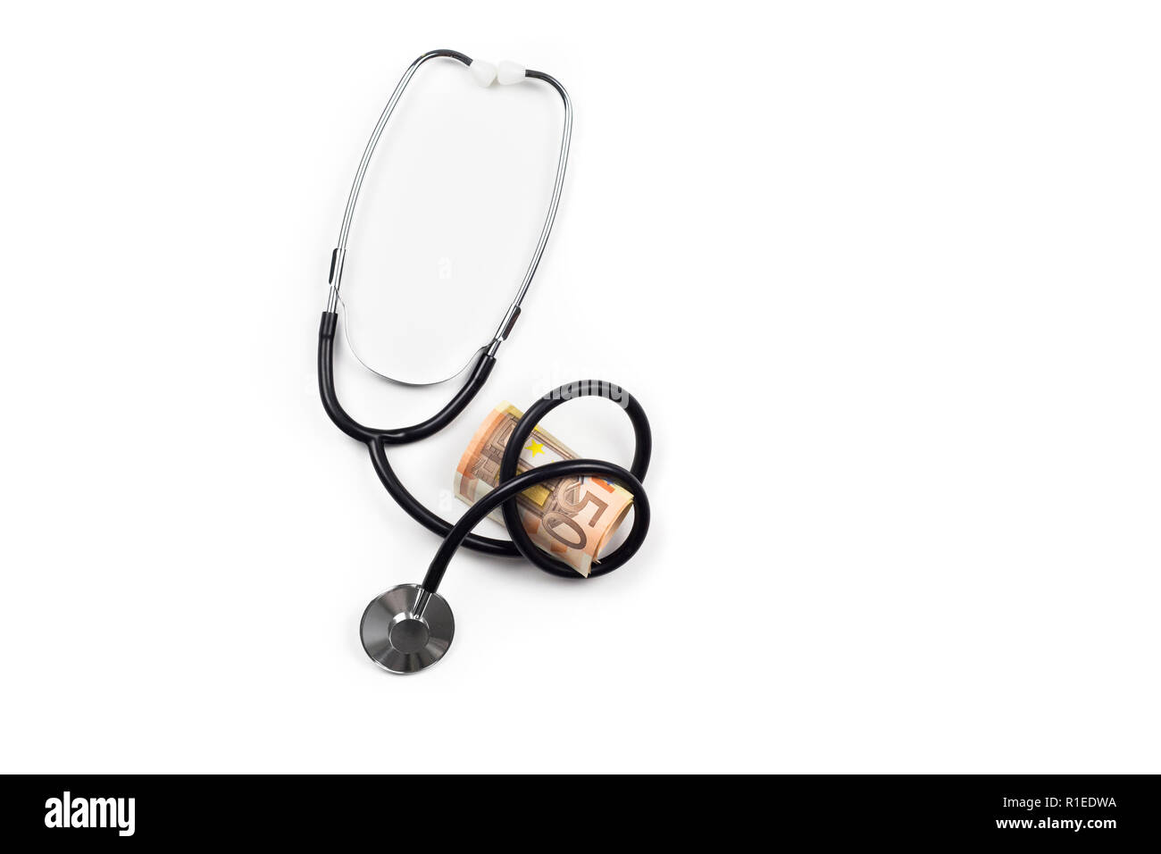 Stethoscope curled around euro money, isolated on white. Bribe in Health Care System in Europe. Stock Photo