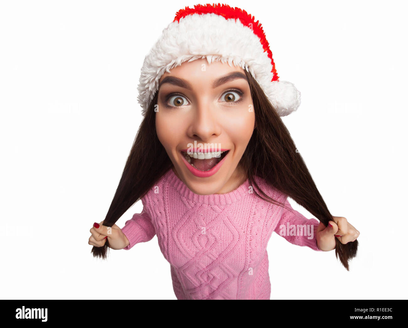 Model in christmas hat pulling hair Stock Photo - Alamy