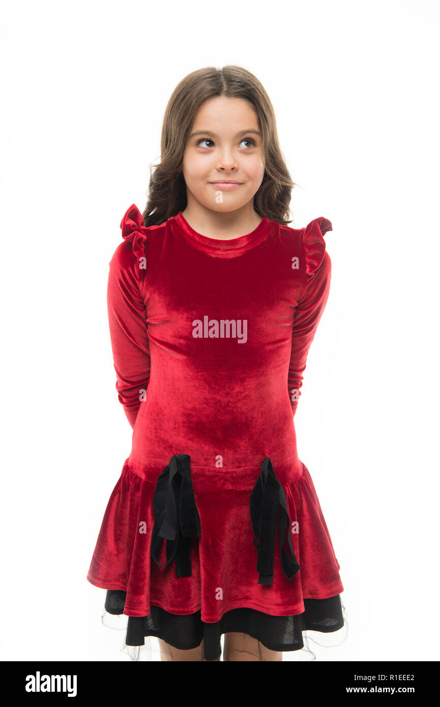 Fashion concept. Kid adorable smiling posing in red velvet dress. Kids  fashion. Girl cute child wear velvet dress. Velvet dress perfect pick  whatever occasion. Feel so trendy in elegant clothes Stock Photo -
