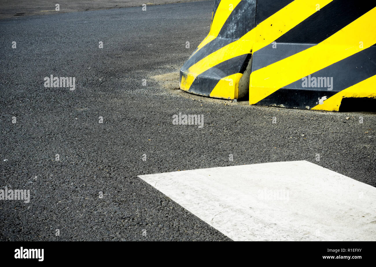 Construction concrete block fence striped yellow black caution pattern ...