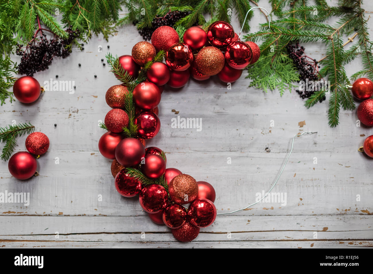 Top view of stages of making Christmas wreath with fir branches and ...
